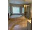 Luxurious bathroom with a soaking tub, glass-enclosed shower, and tiled walls at 1417 Doe Valley Dr, Lithonia, GA 30058