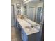 Elegant bathroom with double vanity, large mirror, and tiled walls at 1417 Doe Valley Dr, Lithonia, GA 30058