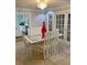 Dining room with a glass table, six chairs, a decorative red vase, and tiled flooring at 1417 Doe Valley Dr, Lithonia, GA 30058