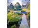 Beautiful home exterior featuring manicured landscaping, mature trees, and a circular driveway at 1417 Doe Valley Dr, Lithonia, GA 30058