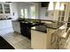 Kitchen area with breakfast bar, pendant lighting, white cabinetry, and black countertops at 1417 Doe Valley Dr, Lithonia, GA 30058
