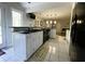 Modern kitchen with white cabinetry, black countertops, and stainless steel appliances at 1417 Doe Valley Dr, Lithonia, GA 30058