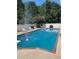 Refreshing pool area with lounge chairs and a white fence, perfect for relaxation and outdoor enjoyment at 1417 Doe Valley Dr, Lithonia, GA 30058