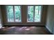Bedroom featuring two windows overlooking a wooded area at 2297 Horseshoe Bend Sw Rd, Marietta, GA 30064