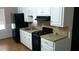 A modern kitchen with white cabinets and black appliances at 2297 Horseshoe Bend Sw Rd, Marietta, GA 30064