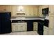 Kitchen with black appliances, tile backsplash, and classic cabinetry at 2297 Horseshoe Bend Sw Rd, Marietta, GA 30064