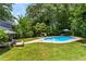 Expansive, lush backyard featuring in-ground pool and patio, perfect for outdoor entertaining at 579 Chapman Dr, Marietta, GA 30066