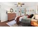 Cozy bedroom featuring a ceiling fan, wood floors, and natural light at 579 Chapman Dr, Marietta, GA 30066