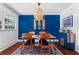 Bright dining room featuring a modern table, blue accent wall, and stylish decor at 579 Chapman Dr, Marietta, GA 30066