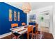 Dining room showcasing unique light fixture, colorful art, and adjacent doorway to the kitchen at 579 Chapman Dr, Marietta, GA 30066
