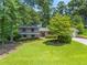 Well-maintained home featuring a lush green lawn and mature trees in a serene setting at 579 Chapman Dr, Marietta, GA 30066