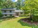 Charming two-story home with manicured front lawn, brick accents, and mature landscaping at 579 Chapman Dr, Marietta, GA 30066