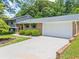 Spacious two-car garage with a long driveway and tidy landscaping at 579 Chapman Dr, Marietta, GA 30066