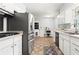 Well-lit kitchen with stainless steel appliances, white cabinetry, and a view to the backyard at 579 Chapman Dr, Marietta, GA 30066