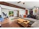 Cozy living room with wood-look floors, exposed beams, and sliding door access to a back patio at 579 Chapman Dr, Marietta, GA 30066