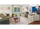 Comfortable living room with a view of the pool through large windows and stylish decor at 579 Chapman Dr, Marietta, GA 30066