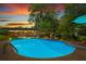 Evening shot showcasing the property's in-ground swimming pool and lush surroundings, lit by soft patio lighting at 579 Chapman Dr, Marietta, GA 30066