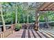 A wooden deck with railing overlooks the lush garden, providing a serene outdoor living space at 335 Pintail Ct, Suwanee, GA 30024