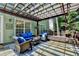 Inviting back patio with a pergola, featuring stylish seating and a tranquil outdoor living space at 335 Pintail Ct, Suwanee, GA 30024