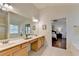 Bright primary bathroom with double vanity, large mirror, soaking tub, and access to bedroom at 335 Pintail Ct, Suwanee, GA 30024