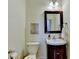 Cozy powder room features a pedestal sink, decorative mirror, and neutral decor at 335 Pintail Ct, Suwanee, GA 30024
