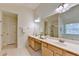 Bright primary bathroom with double vanity, large mirror, and soaking tub at 335 Pintail Ct, Suwanee, GA 30024