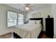 Comfortable bedroom with wood floors, natural light, and ceiling fan at 335 Pintail Ct, Suwanee, GA 30024