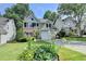 Charming home with well-kept lawn and garden, with blooming lilies in the front yard at 335 Pintail Ct, Suwanee, GA 30024
