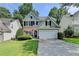 Charming two-story home featuring a brick and siding exterior with a well-manicured lawn and two-car garage at 335 Pintail Ct, Suwanee, GA 30024