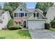 Inviting two-story home with a brick and siding facade, featuring a well-maintained lawn and a spacious two-car garage at 335 Pintail Ct, Suwanee, GA 30024