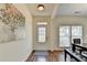 Bright foyer with hardwood floors, white walls, and a decorative painting, leading to the main living area at 335 Pintail Ct, Suwanee, GA 30024