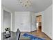 Hallway featuring a set of closets, a hanging chandelier and wood flooring at 335 Pintail Ct, Suwanee, GA 30024