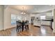 Eat-in kitchen includes white cabinets, an island, stainless appliances, and hardwood floors at 335 Pintail Ct, Suwanee, GA 30024