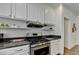 Well-equipped kitchen with stainless steel appliances and white cabinets provides a modern cooking space at 335 Pintail Ct, Suwanee, GA 30024
