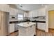 Updated kitchen features stainless appliances, an island, white cabinets, and hardwood floors at 335 Pintail Ct, Suwanee, GA 30024