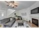 Comfortable living room featuring a fireplace, ceiling fan and hardwood floors at 335 Pintail Ct, Suwanee, GA 30024