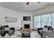 Inviting living room with hardwood floors, a fireplace, comfortable seating, and a large window offering natural light at 335 Pintail Ct, Suwanee, GA 30024