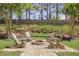 Backyard fire pit area with Adirondack chairs and gravel at 4765 Silver Leaf Dr, Cumming, GA 30040