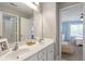Bright bathroom featuring double sinks, white countertops, and a large mirror at 4765 Silver Leaf Dr, Cumming, GA 30040