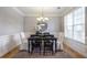 Dining room with neutral walls, hardwood floors, natural light and a dark wood table set for a meal at 4765 Silver Leaf Dr, Cumming, GA 30040