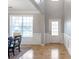 Open entryway with hardwood floors and white wainscoting is adjacent to the dining room at 4765 Silver Leaf Dr, Cumming, GA 30040