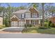 Charming two-story brick home with a three-car garage and well-manicured lawn at 4765 Silver Leaf Dr, Cumming, GA 30040