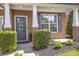 Inviting entryway with brick facade, manicured bushes and a dark blue front door adds to the curb appeal at 4765 Silver Leaf Dr, Cumming, GA 30040