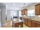 Open kitchen with granite countertops, a center island and a dining area at 4765 Silver Leaf Dr, Cumming, GA 30040