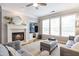Stylish living room boasts a fireplace, hardwood floors, natural light and comfortable grey couches at 4765 Silver Leaf Dr, Cumming, GA 30040