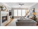 The living room features a fireplace, hardwood floors, lots of natural light and comfortable seating at 4765 Silver Leaf Dr, Cumming, GA 30040