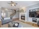 Inviting living room features a fireplace and a ceiling fan to provide comfort and style at 4765 Silver Leaf Dr, Cumming, GA 30040