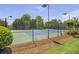 Outdoor tennis court with lighting surrounded by green landscape and fence at 4765 Silver Leaf Dr, Cumming, GA 30040