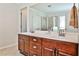 Bathroom with double sink vanity, wood cabinets, large mirror and glass shower at 705 Chanson Sw Dr, Marietta, GA 30064