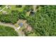 A high aerial view shows the house in its neighborhood setting and surrounding woods and pond at 287 Flower Farm Dr, Acworth, GA 30101